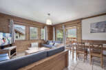 This cozy living space features a rustic wooden interior, creating a warm and inviting atmosphere.