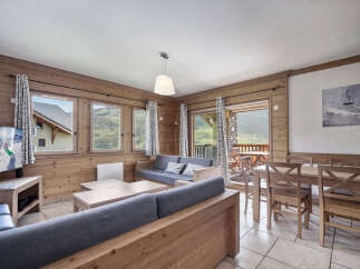This cozy living space features a rustic wooden interior, creating a warm and inviting atmosphere.