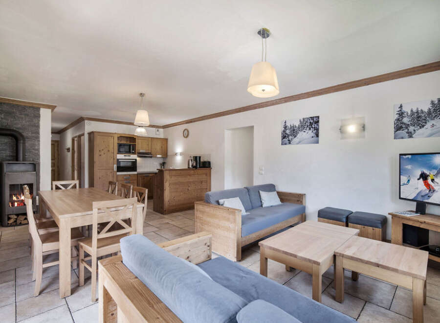 This charming property boasts a cozy living space, perfect for relaxing after a day on the slopes.