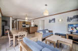 This charming property boasts a cozy living space, perfect for relaxing after a day on the slopes.