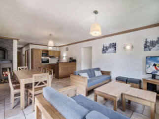 This charming property boasts a cozy living space, perfect for relaxing after a day on the slopes.