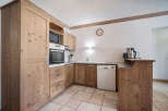 This charming kitchen boasts beautiful wooden cabinetry and a modern design.