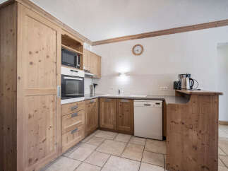 This charming kitchen boasts beautiful wooden cabinetry and a modern design.