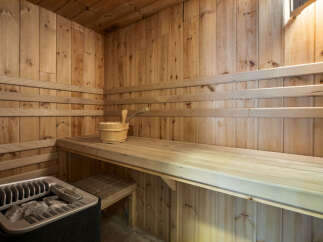 Step into relaxation with this stunning sauna! Featuring beautiful wooden interiors and comfortable seating, this space is perfect for unwinding.