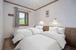 This cozy bedroom features two twin beds, perfect for a comfortable stay.
