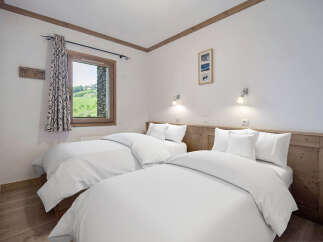 This cozy bedroom features two twin beds, perfect for a comfortable stay.
