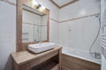 This charming bathroom features a rustic wooden vanity and mirror frame, creating a warm and inviting atmosphere.