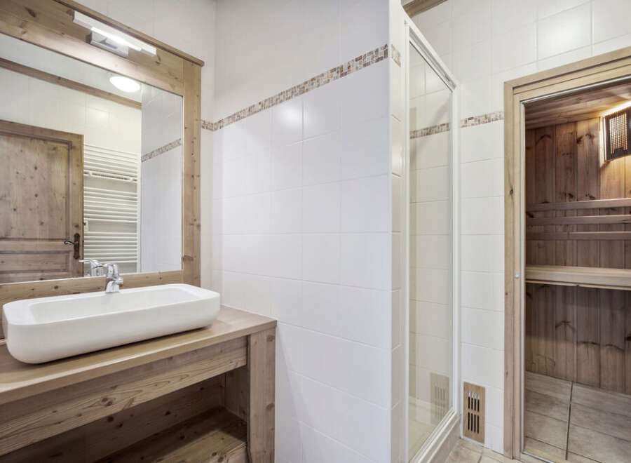 This stunning bathroom features a modern design with a touch of rustic charm.