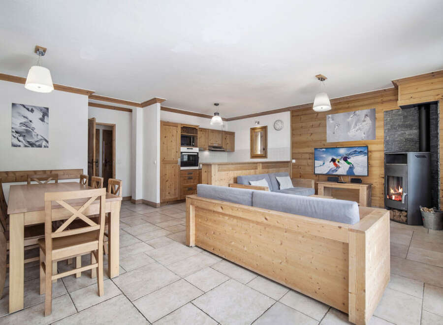 Experience the charm of this stunning property, featuring a cozy living area with a fireplace and a modern kitchen.