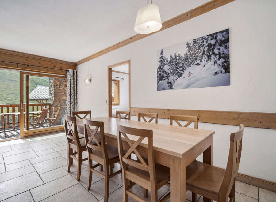 This stunning dining area offers a warm and inviting atmosphere, perfect for enjoying meals with family and friends.