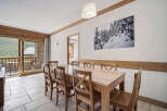 This stunning dining area offers a warm and inviting atmosphere, perfect for enjoying meals with family and friends.