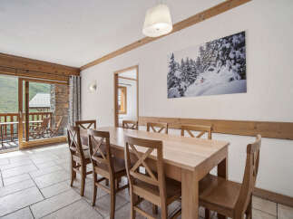 This stunning dining area offers a warm and inviting atmosphere, perfect for enjoying meals with family and friends.