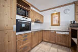 This charming kitchen features warm wooden cabinetry, creating a cozy and inviting atmosphere.