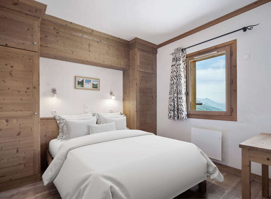 This cozy bedroom features a rustic wooden design, creating a warm and inviting atmosphere.