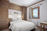 This cozy bedroom features a rustic wooden design, creating a warm and inviting atmosphere.