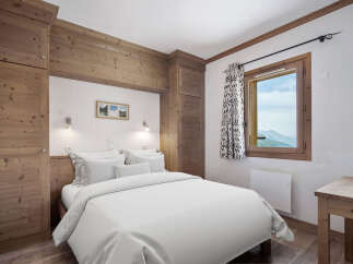 This cozy bedroom features a rustic wooden design, creating a warm and inviting atmosphere.
