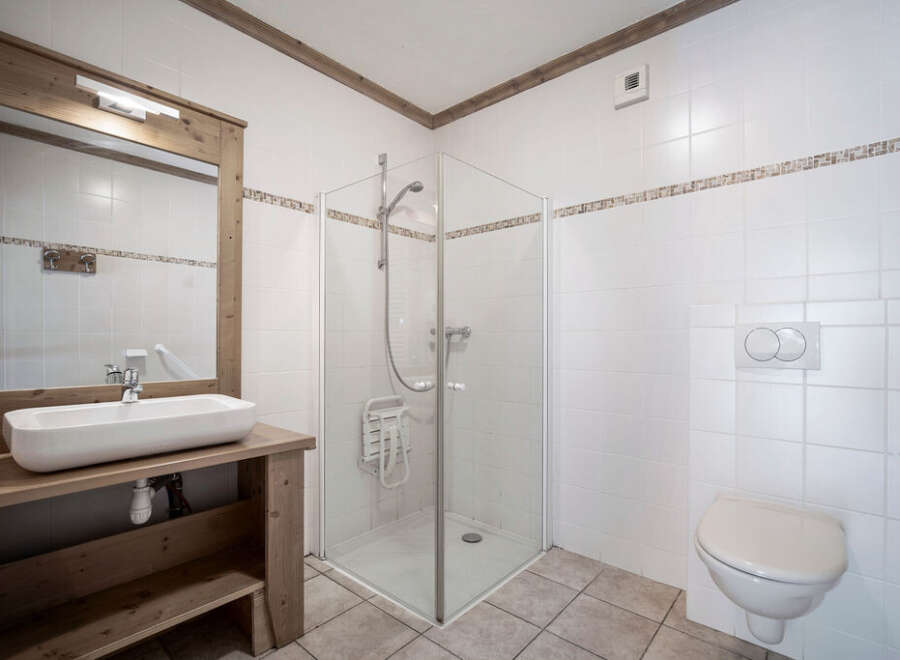 This charming bathroom features a modern design with a spacious shower and a stylish sink.