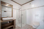 This charming bathroom features a modern design with a spacious shower and a stylish sink.