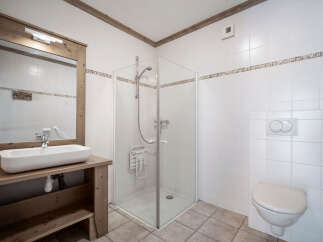 This charming bathroom features a modern design with a spacious shower and a stylish sink.