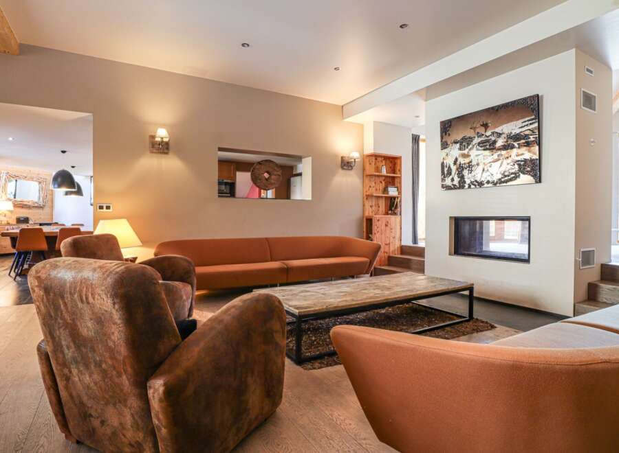 Step into luxury with this stunning living room, featuring a cozy fireplace and stylish seating.