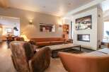 Step into luxury with this stunning living room, featuring a cozy fireplace and stylish seating.
