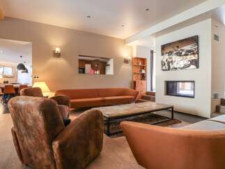 Step into luxury with this stunning living room, featuring a cozy fireplace and stylish seating.