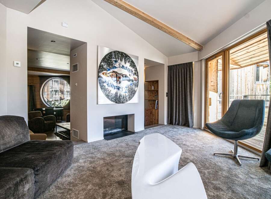 Experience luxury living in this stunning property, featuring a cozy fireplace and a modern, white coffee table.