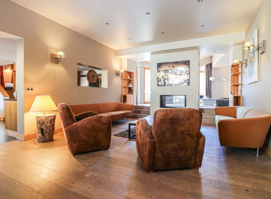 Discover the epitome of luxury living in this stunning property, featuring a cozy living room with a fireplace, perfect for relaxing evenings.