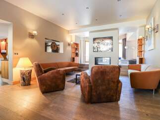 Discover the epitome of luxury living in this stunning property, featuring a cozy living room with a fireplace, perfect for relaxing evenings.