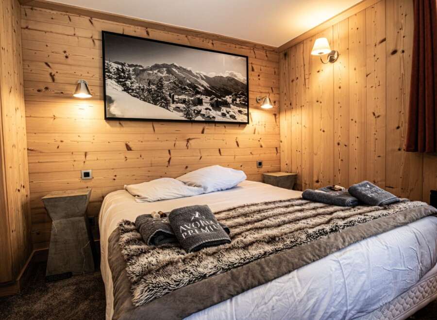 This cozy bedroom features a rustic wooden interior, creating a warm and inviting atmosphere.