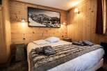 This cozy bedroom features a rustic wooden interior, creating a warm and inviting atmosphere.