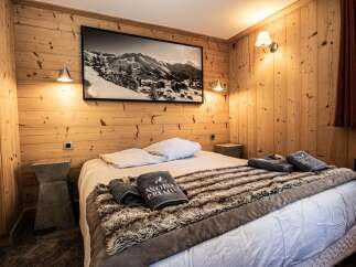 This cozy bedroom features a rustic wooden interior, creating a warm and inviting atmosphere.
