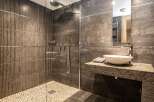 Step into luxury with this stunning bathroom featuring a modern design and high-end finishes.