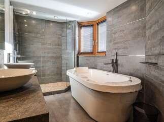 Indulge in luxury within this stunning bathroom, featuring a sleek, modern design.