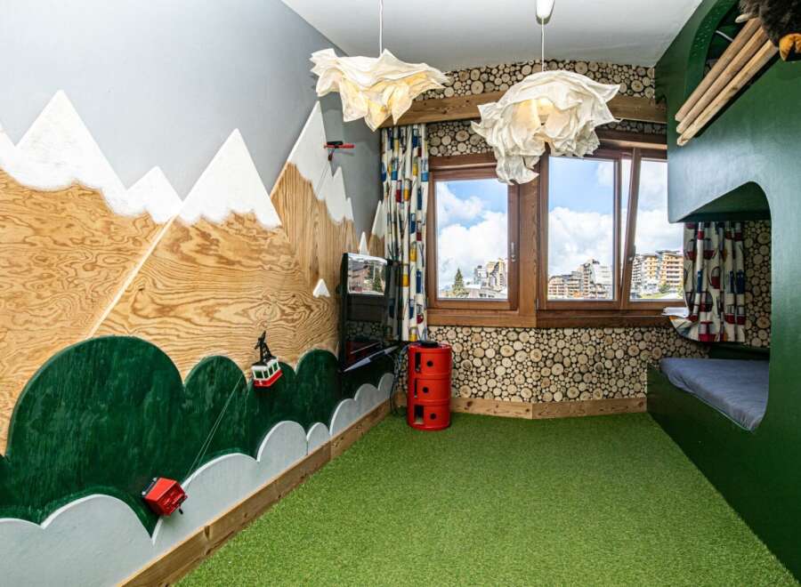 This unique bedroom features a whimsical mountain-themed design, perfect for sparking imagination.