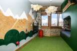 This unique bedroom features a whimsical mountain-themed design, perfect for sparking imagination.