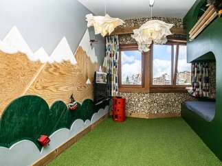 This unique bedroom features a whimsical mountain-themed design, perfect for sparking imagination.