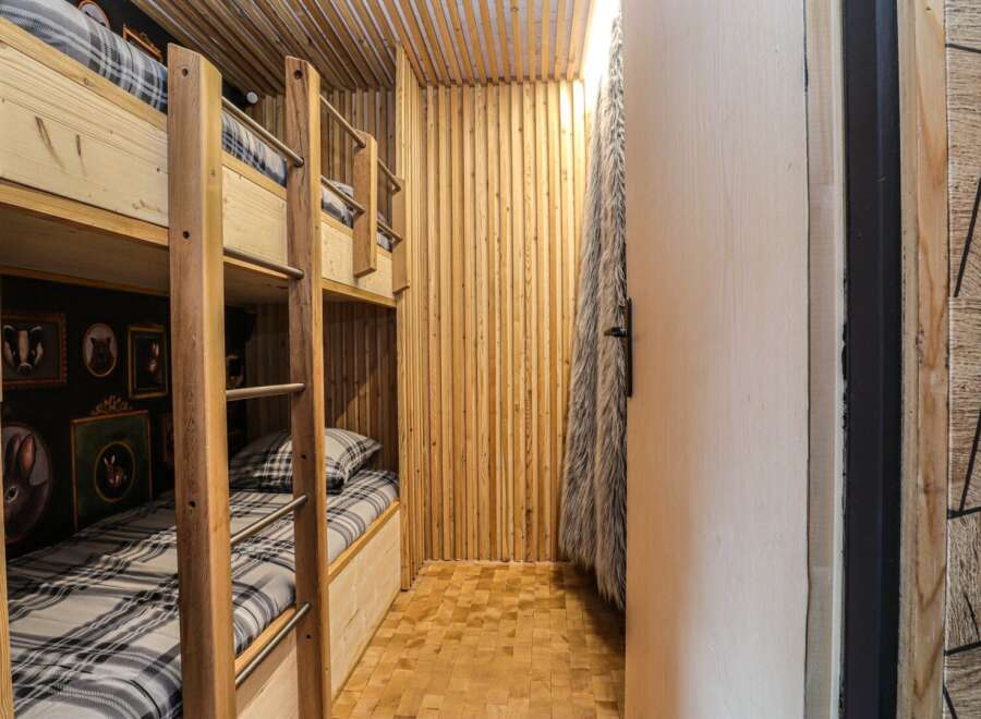 Step into this cozy bunk room, perfect for a family getaway or a fun space for kids.
