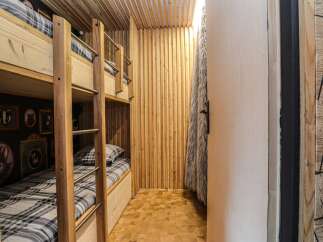 Step into this cozy bunk room, perfect for a family getaway or a fun space for kids.