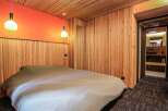 This cozy bedroom features a unique wooden paneling design, creating a warm and inviting atmosphere.