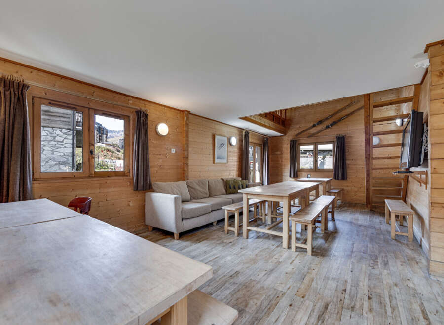 This charming wooden cabin offers a cozy and inviting atmosphere, perfect for a relaxing getaway.
