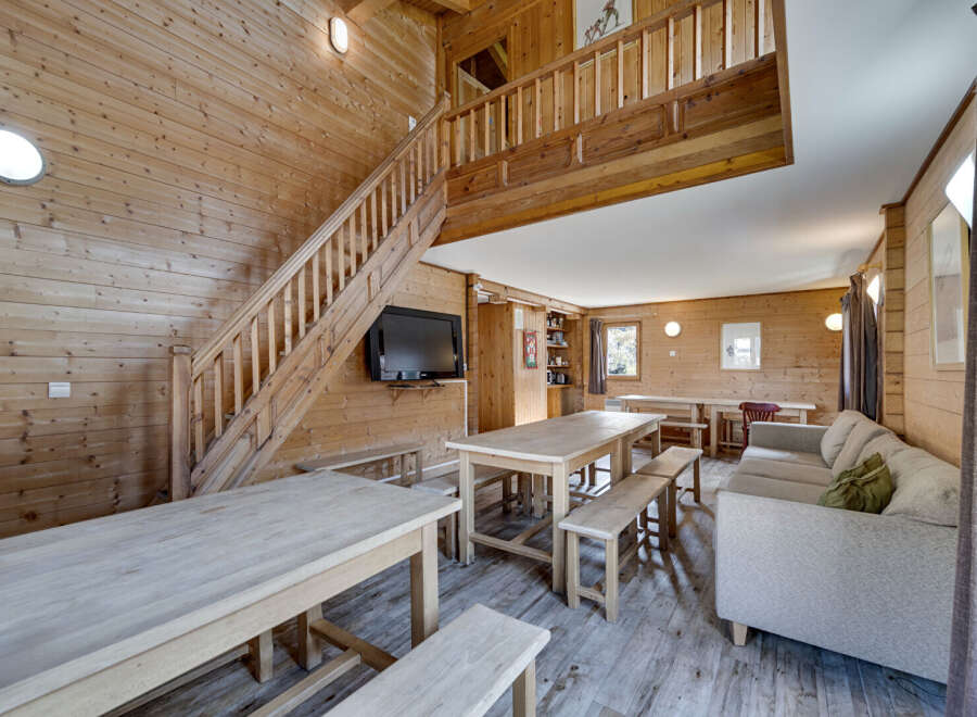 This stunning property boasts a warm and inviting interior, featuring beautiful wooden paneling throughout.