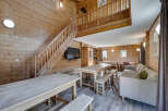 This stunning property boasts a warm and inviting interior, featuring beautiful wooden paneling throughout.
