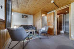 Discover a cozy retreat in this charming property, featuring a warm wooden ceiling and walls that create a welcoming atmosphere.
