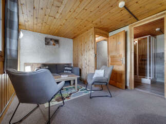 Discover a cozy retreat in this charming property, featuring a warm wooden ceiling and walls that create a welcoming atmosphere.
