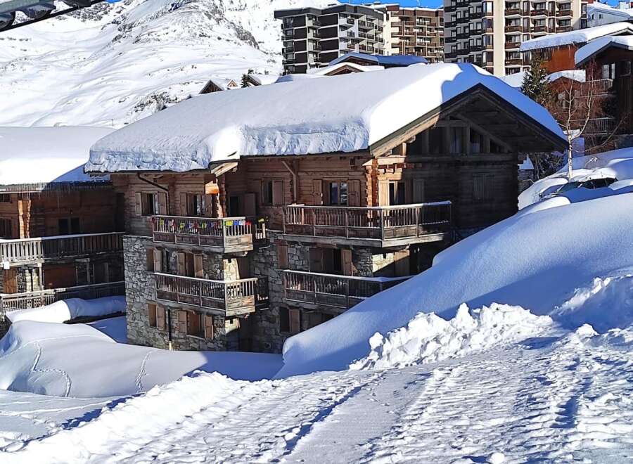 Discover the charm of this stunning chalet nestled in a snowy mountain landscape.