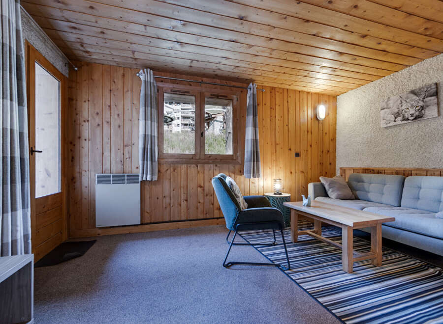 Step into this cozy cabin retreat, featuring warm wooden walls and a charming ambiance.