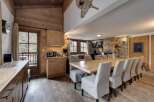 Experience the charm of this stunning property, featuring a spacious dining area with a large wooden table and comfortable seating.