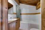 This charming bathroom features a unique design with wooden accents and a cozy atmosphere.