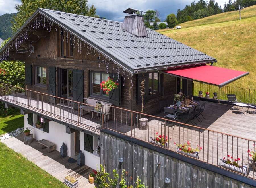 This charming chalet-style home offers a perfect blend of rustic charm and modern comfort.